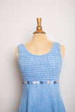 1990's Denim baby doll sleeveless mini dress with a smock bodice and daisy appliques