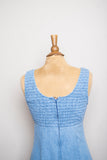 1990's Denim baby doll sleeveless mini dress with a smock bodice and daisy appliques