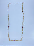 Long gold necklace with purple