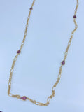 Long gold necklace with purple