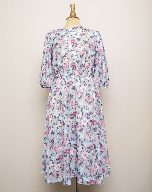 1970's Grey dress with pastel pink, violet & blue roses with a tie keyhole and puff sleeve