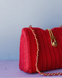 Red Wicker Purse w/gold chain shoulder strap.