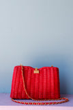 Red Wicker Purse w/gold chain shoulder strap.