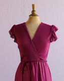 1970's Magenta dress with ruffle sleeves, elastic waistband, faux wrap bodice and asymmetrical ruffle hem.