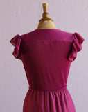 1970's Magenta dress with ruffle sleeves, elastic waistband, faux wrap bodice and asymmetrical ruffle hem.