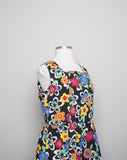 1990's Black sleeveless Plus Size dress with a primary colored flowers, back smocking & 1 pocket