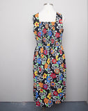 1990's Black sleeveless Plus Size dress with a primary colored flowers, back smocking & 1 pocket