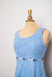 1990's Denim baby doll sleeveless mini dress with a smock bodice and daisy appliques