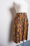 1990's Gold & Black animal print plus size skirt with medallion & tassle print.