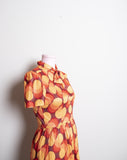 1970's inspired Brown and orange short sleeve mini dress with bow tie in a abstract circular print