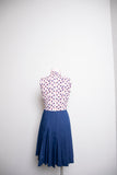 1960-70’s White sleeveless cotton mini dress with a red floral print & navy box pleated skirt