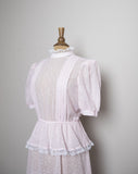 1970's Pink sheer polka dot prairie dress with puff sleeves, peplum skirt and laced highneck