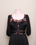 1970's Black prairie style puff sleeve dress with floral trim and corset lacing on bodice