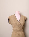 1970's Sleeveless Tan A-line dress with a faux wrap bodice and black trim detail