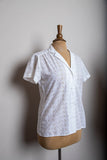 1980's White eyelet short sleeve button down shirt with embroidered florals.