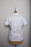 1980's White eyelet short sleeve button down shirt with embroidered florals.
